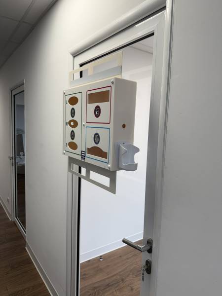 distributeur precobox preciosa 6 epi fixé par ventouse sur une porte vitrée avec pictogrammes colorés